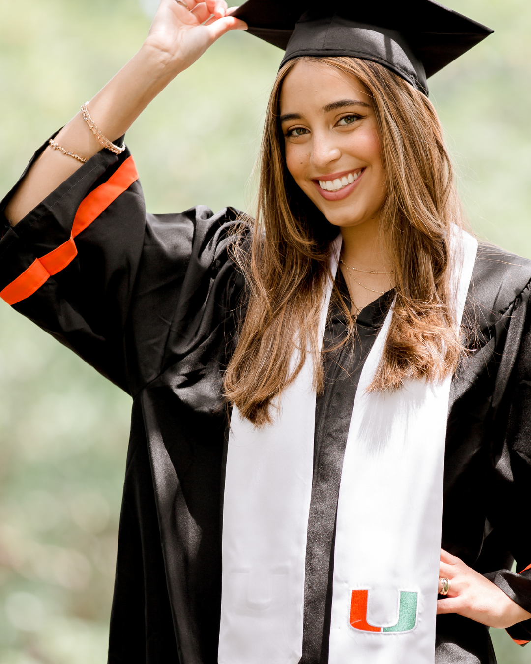 Graduate celebrating in cap and gown