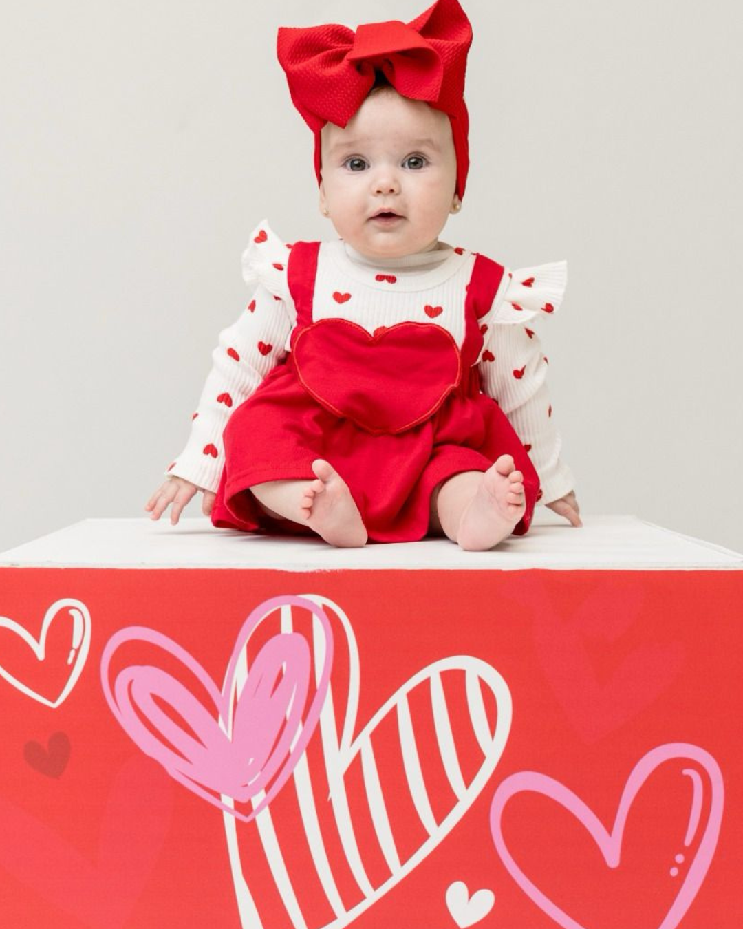 Baby portrait in a heart-themed studio setup